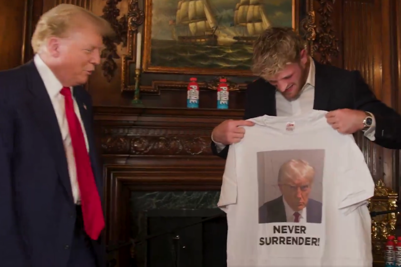 Donald Trump presents Logan Paul with a T-shirt bearing his mugshot ahead of their podcast interview on June 13